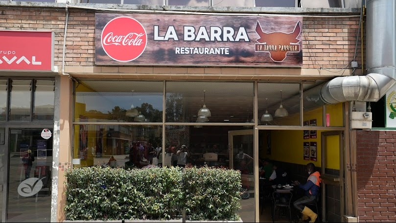 Fachada de un local comercial en donde hay un aviso que dice "Restaurante La Barra".